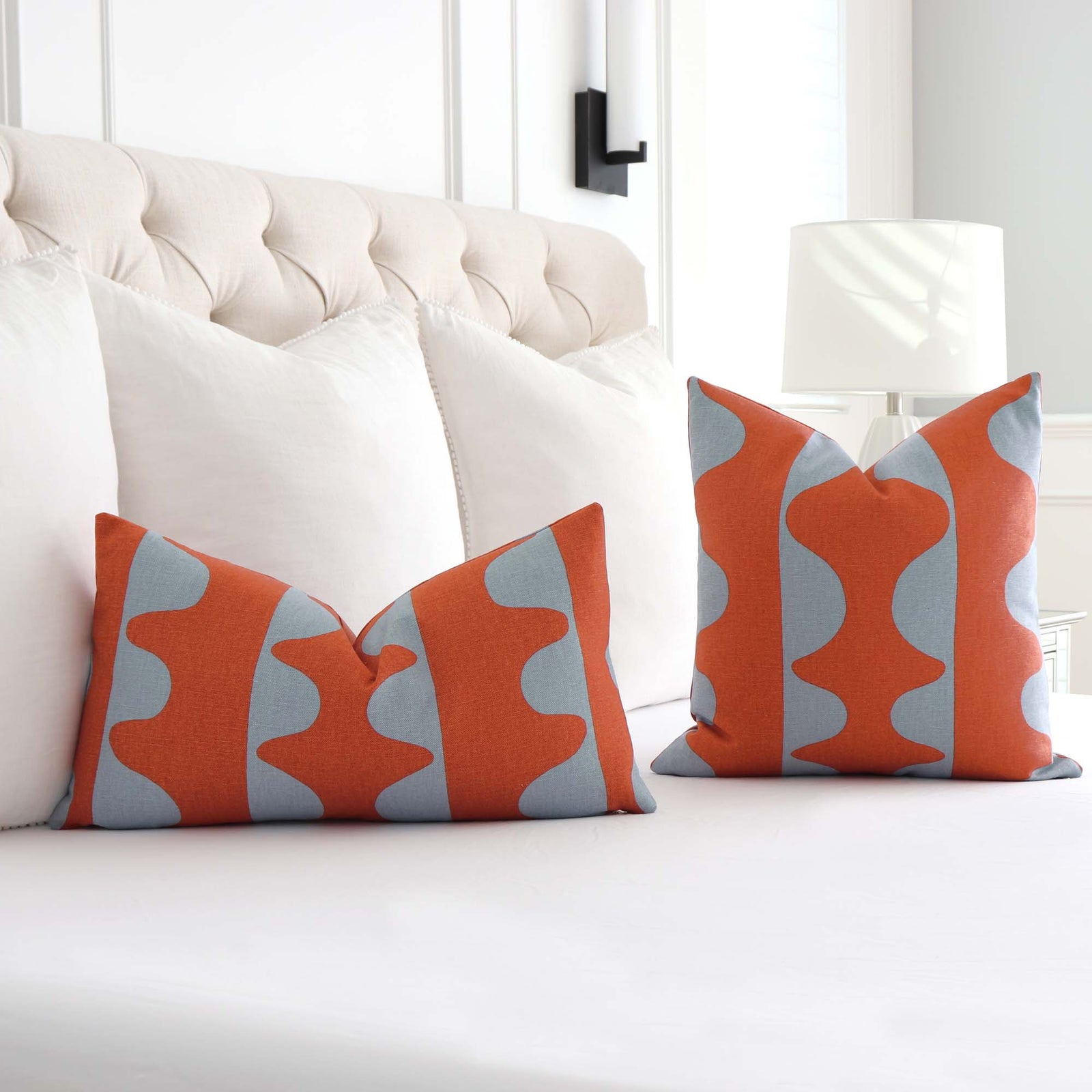 Schumacher Hadiya Williams Drift Hand Printed Currant Orange and Turquoise Geometric Stripe Designer Throw Pillow Cover on Bed with White Euro Pillows