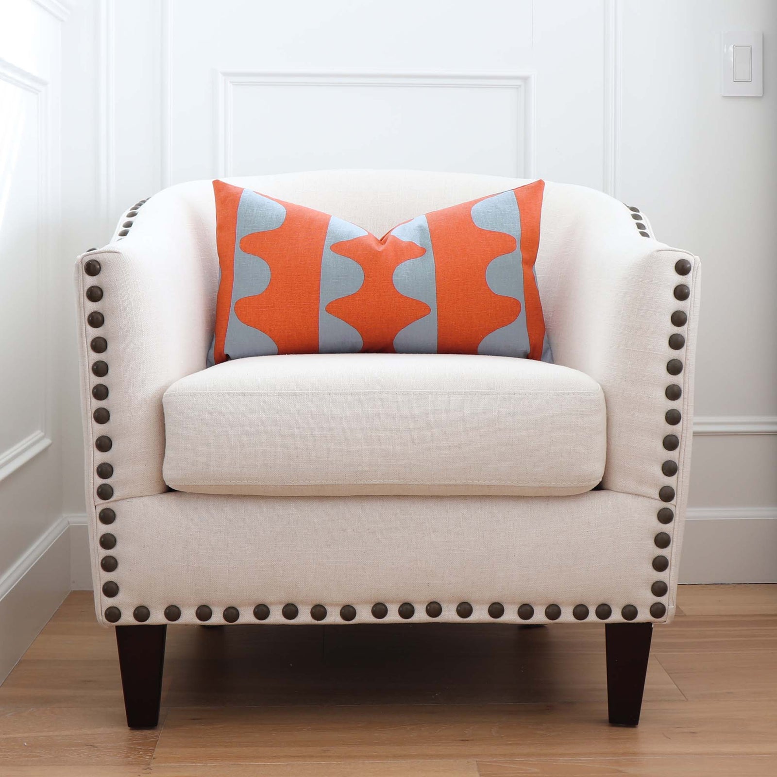 Schumacher Hadiya Williams Drift Hand Printed Currant Orange and Turquoise Geometric Stripe Designer Throw Pillow Cover on Accent Chair