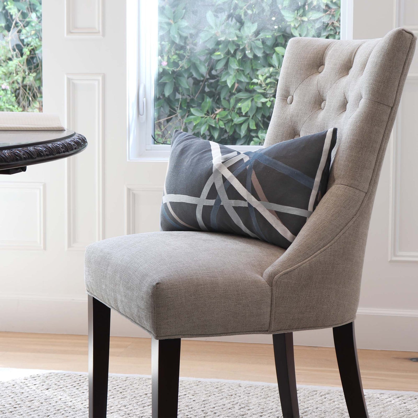 Kelly Wearstler Simpatico Raven Striped Dark Gray Designer Decorative Lumbar Throw Pillow Cover on Chair in Dining Room