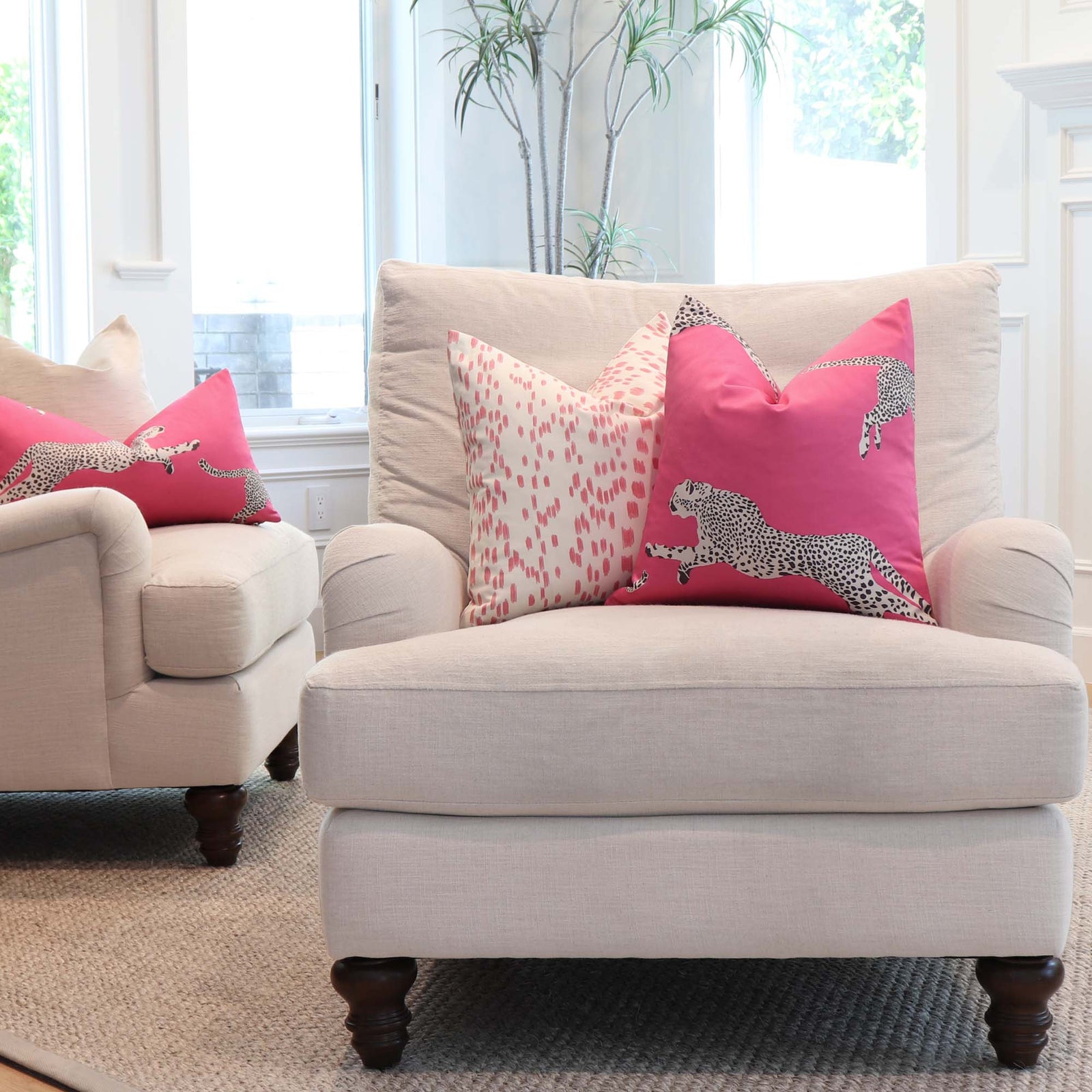 Scalamandre Leaping Cheetah Bubblegum Pink Animal Print Luxury Decorative Throw Pillow Cover in Living Room on Comfy White Arm Chairs