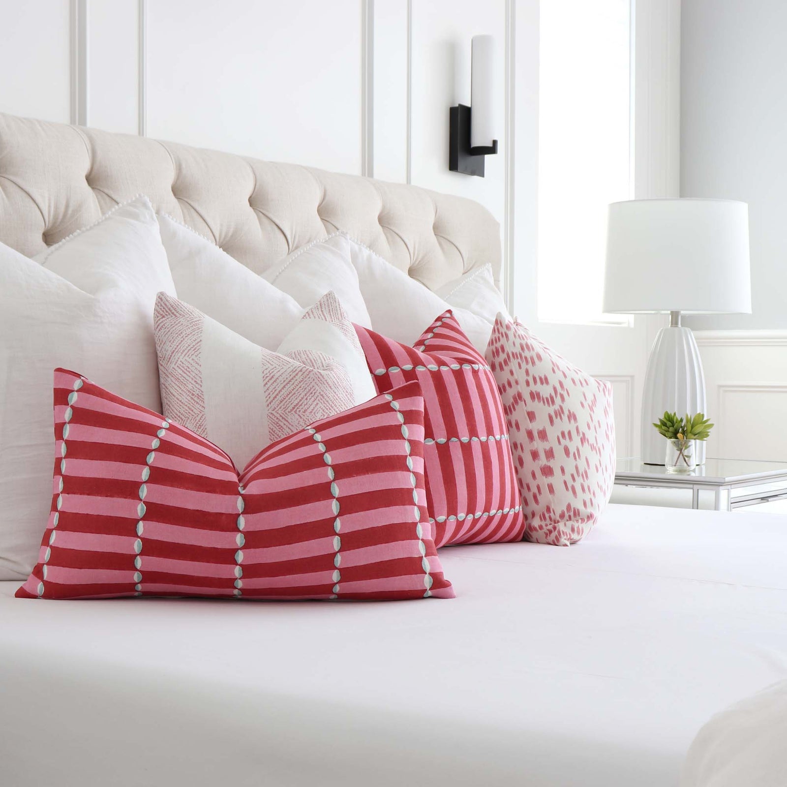 Schumacher Luna Pink and Red Block Print Designer Luxury Decorative Throw Pillow Cover On King Bed with Coordinating Throw Pillows