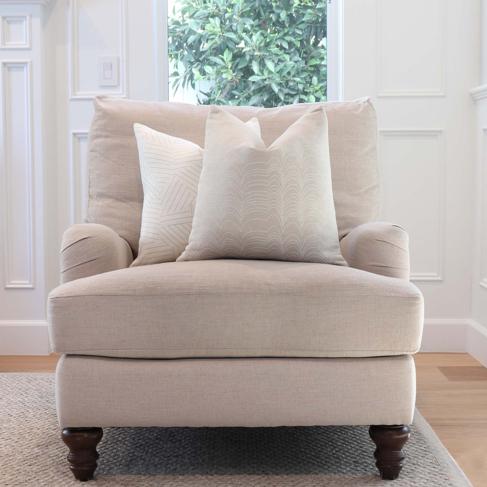 Schumacher Richter Natural and Ivory Striped Designer Throw Pillow Cover on comfy Arm Chair