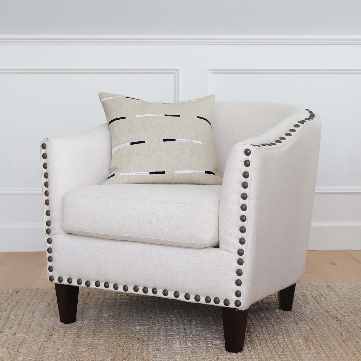 Schumacher x Caroline Z Hurley Overlapping Dashes Hand Block Designer Throw Pillow Cover on Accent Chair with Nail Heads
