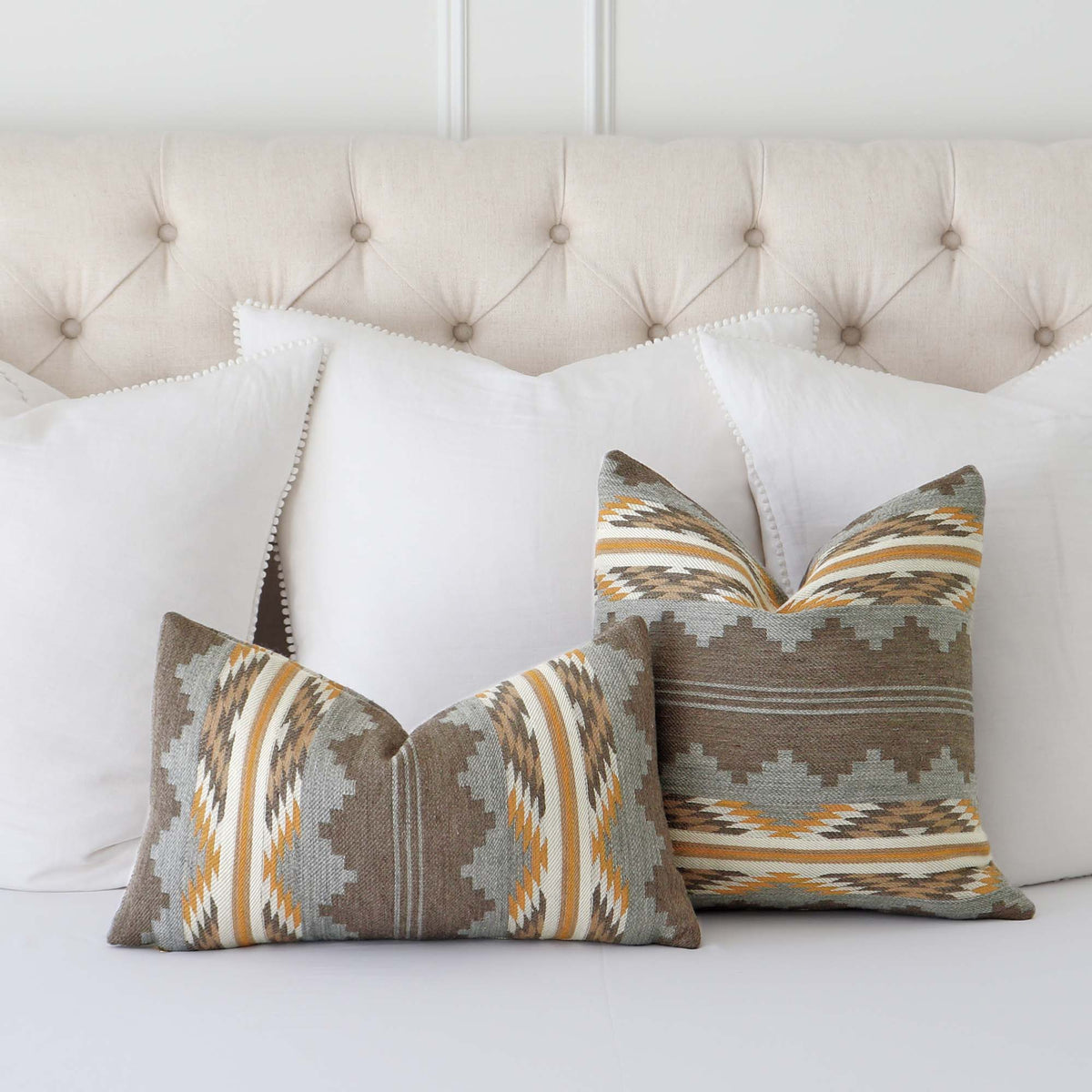 Schumacher Monsoon Neutral Burnt Orange Southwestern Geometric Wool Luxury Designer Throw Pillow Cover on Bed with Large White Euro Shams