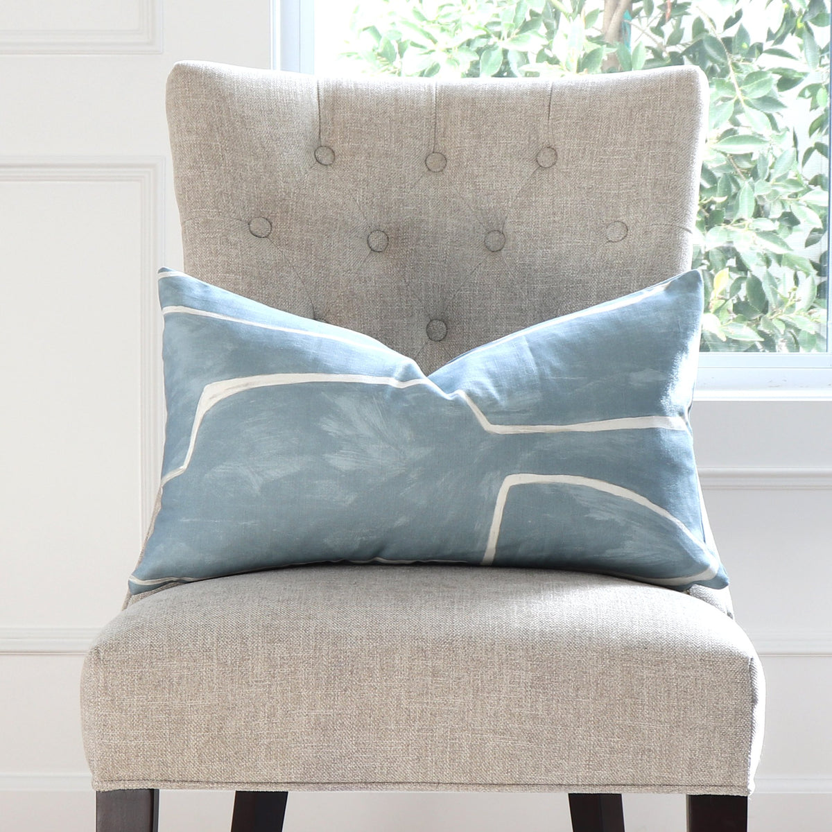 Kelly Wearstler Graffito Deep Sky Lumbar Throw Pillow Cover on Accent Chair