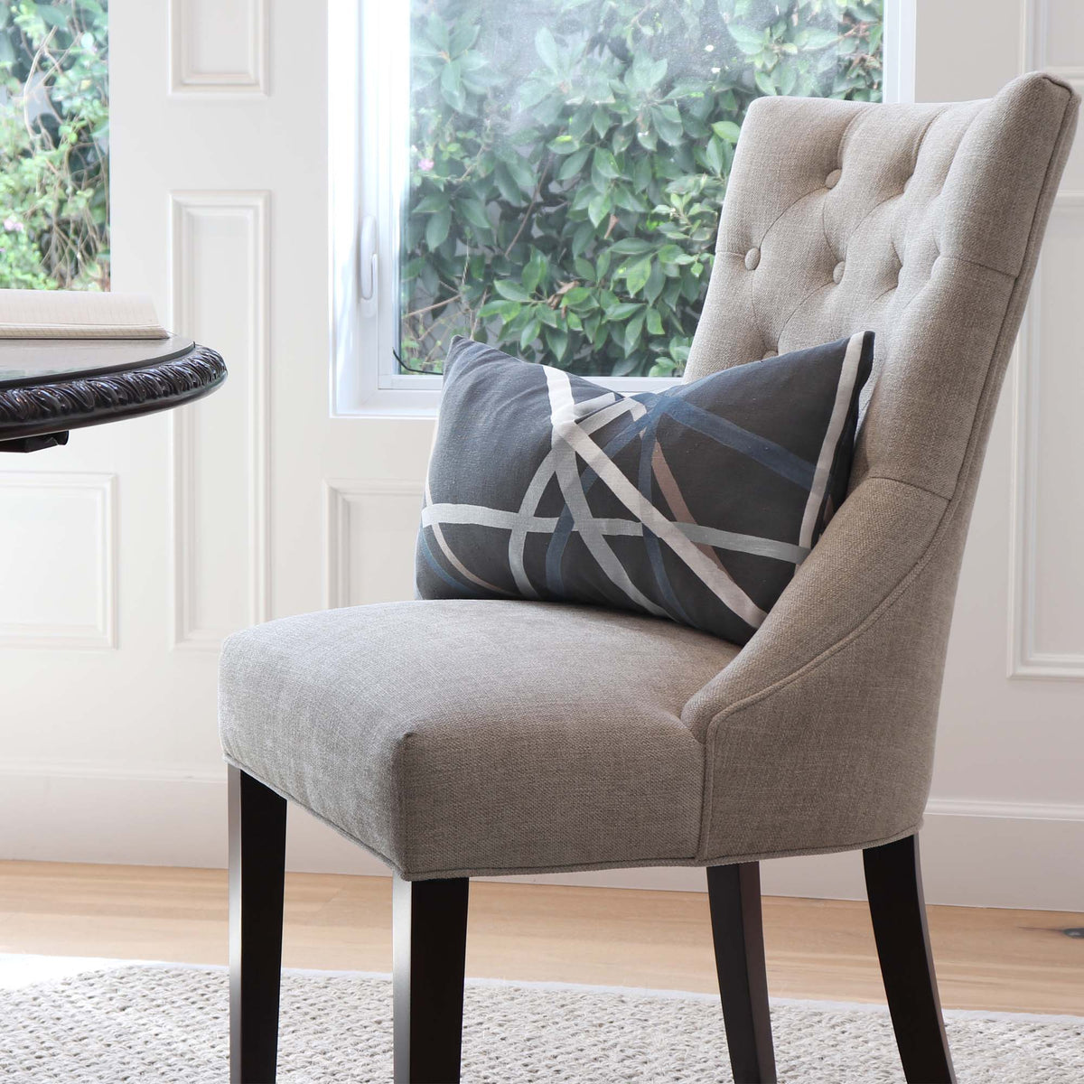 Kelly Wearstler Simpatico Raven Striped Dark Gray Designer Decorative Lumbar Throw Pillow Cover on Chair in Dining Room