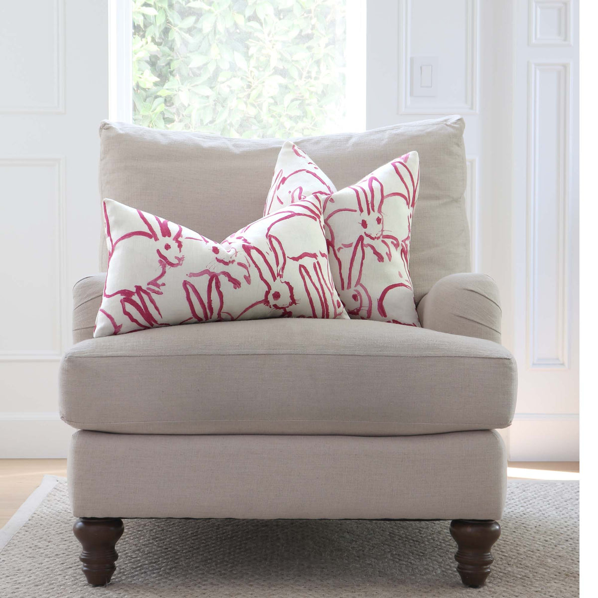 Lee Jofa Groundworks Hutch Pink Bunny Designer Throw Pillow Cover on Arm Chair in Living Room