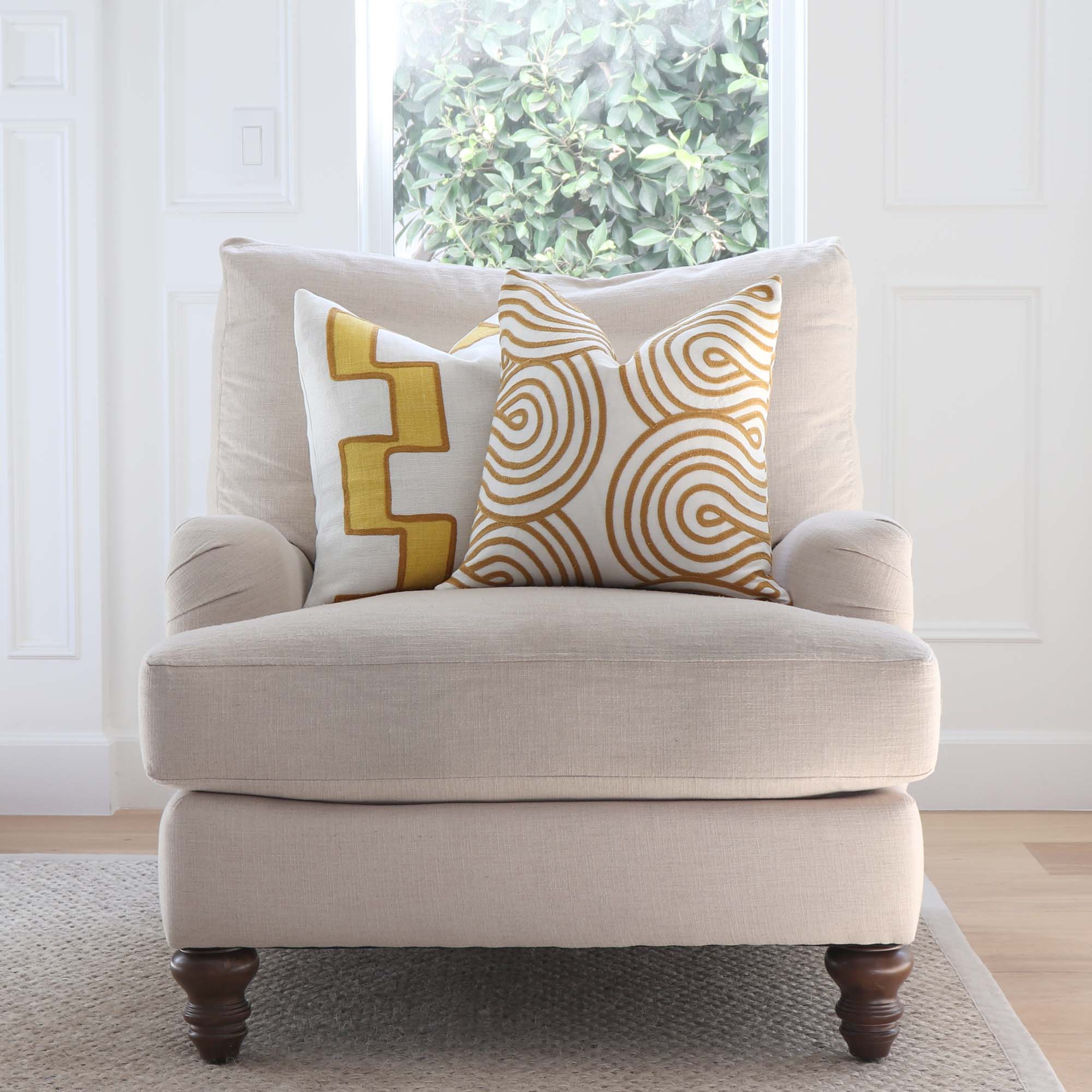 https://www.chloeandolive.com/cdn/shop/products/Schumacher-Giraldi-Embroidery-Gold-Yellow-Luxury-Designer-Throw-Pillow-Cover-in-Living-Room-on-Club-Chair_5000x.jpg?v=1649433449