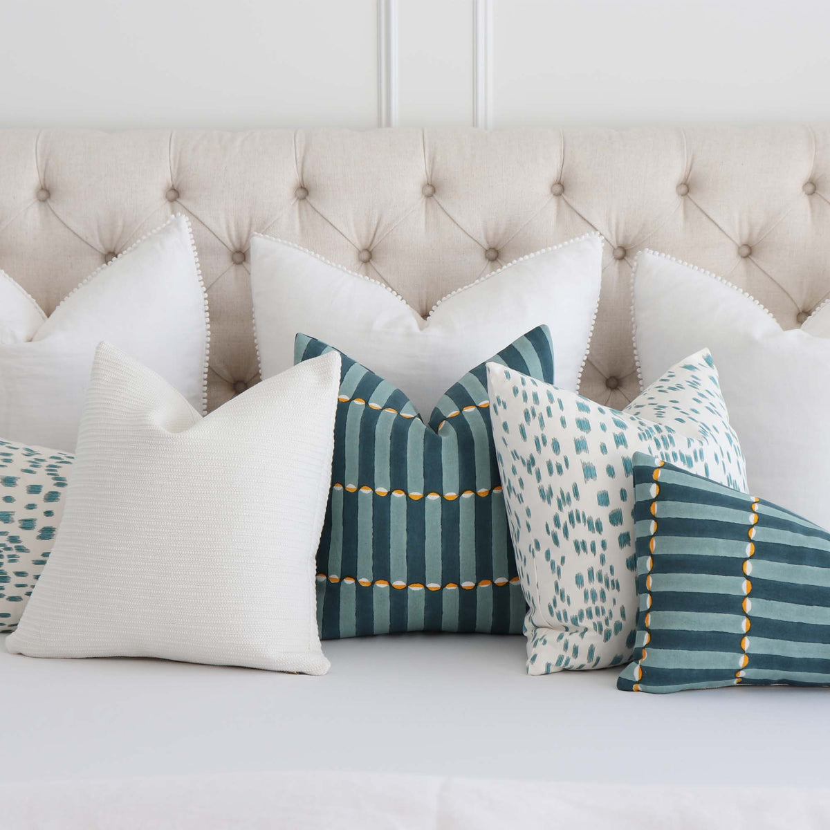 Schumacher Luna Blue and Turmeric Graphic Block Print Designer Decorative Throw Pillow Cover with Coordinating Throw Pillows on Bed