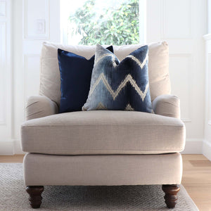 Schumacher Shock Wave Velvet Midnight Blue Designer Throw Pillow on Arm Chair in Living Room