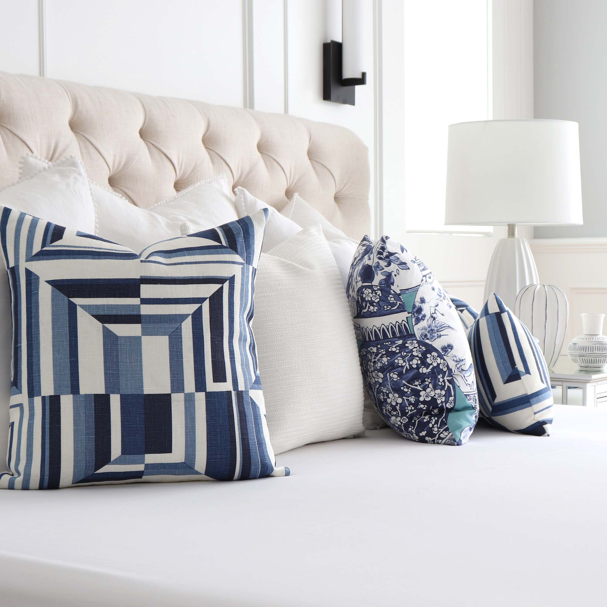 WHite and blue pillows accent a white linen couch placed in a