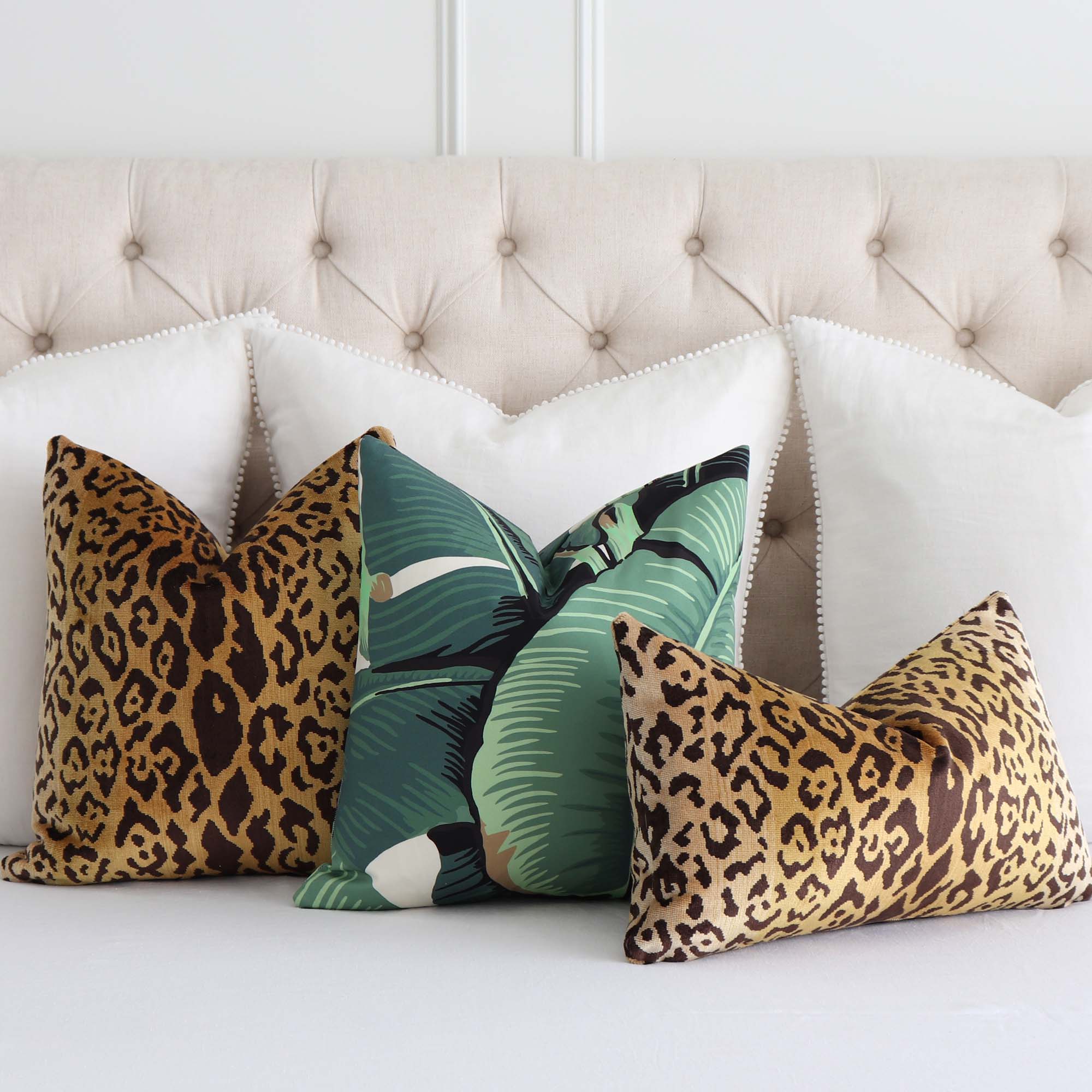 https://www.chloeandolive.com/cdn/shop/products/scalamandre-hinson-palm-green-HN000142010-banana-leaf-botanical-designer-luxury-throw-pillow-cover-on-white-bed-with-fun-throw-pillows_5000x.jpg?v=1676437625